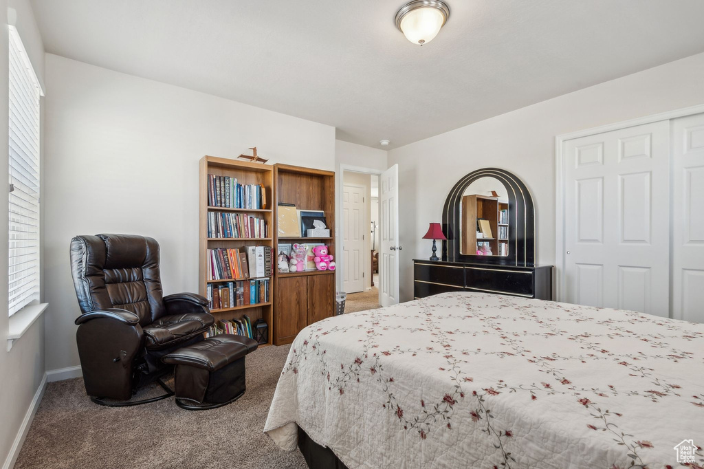 Bedroom featuring carpet floors and a closet