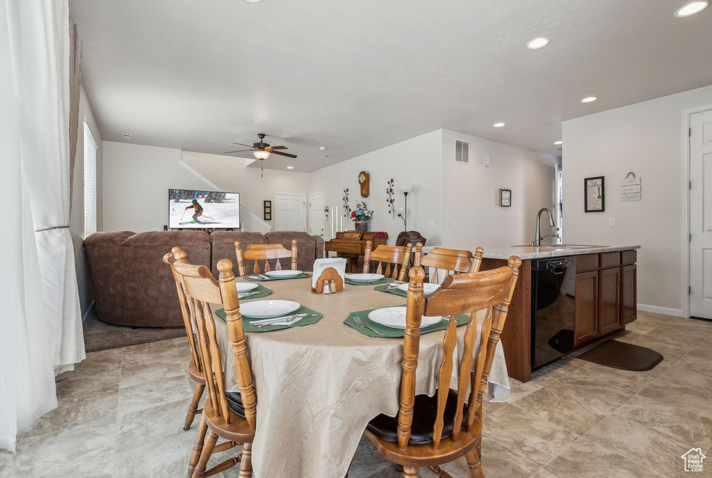 Dining room with ceiling fan and sink