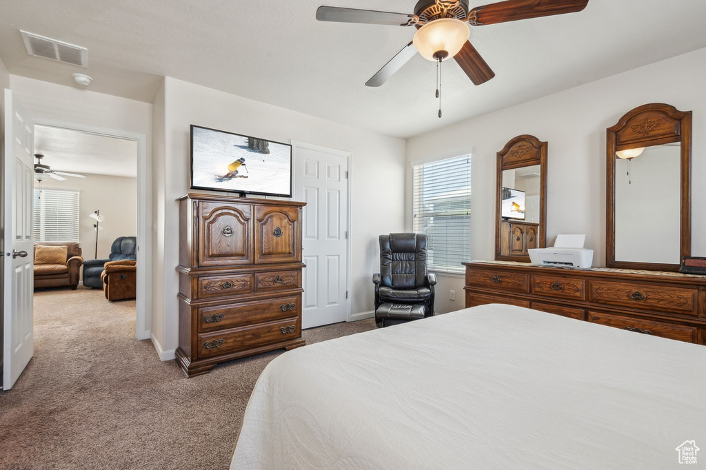 Bedroom featuring ceiling fan and light colored carpet