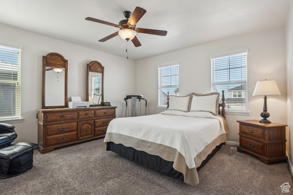 Carpeted bedroom featuring ceiling fan