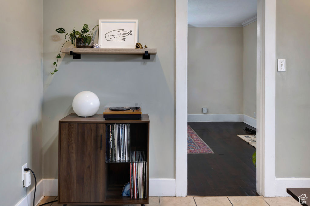 Interior space featuring tile patterned floors and crown molding