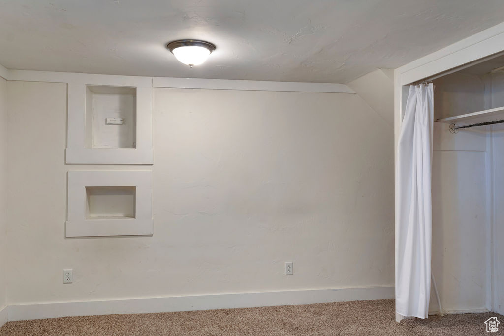 Basement with light carpet