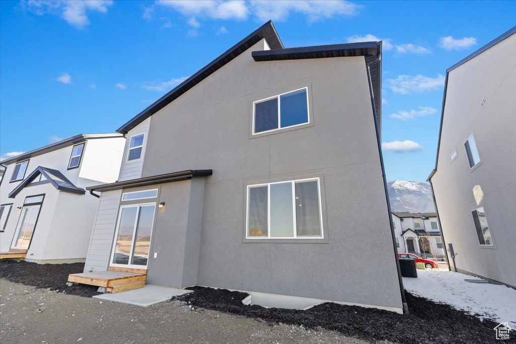 Back of property featuring stucco siding