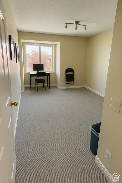 Sitting room featuring carpet flooring and baseboards
