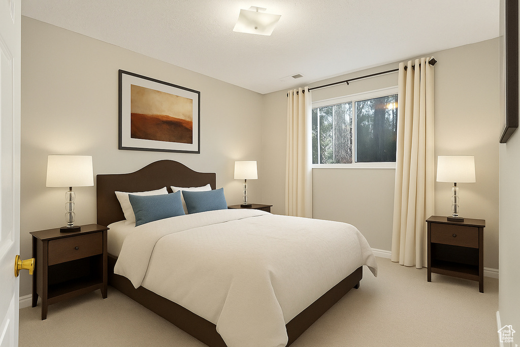 Bedroom featuring light colored carpet and baseboards