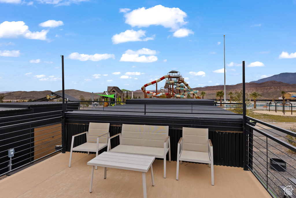 View of patio with a balcony and a mountain view