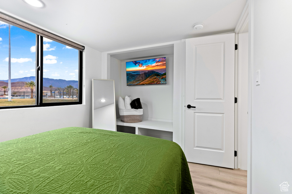 Bedroom featuring light wood-type flooring and a mountain view