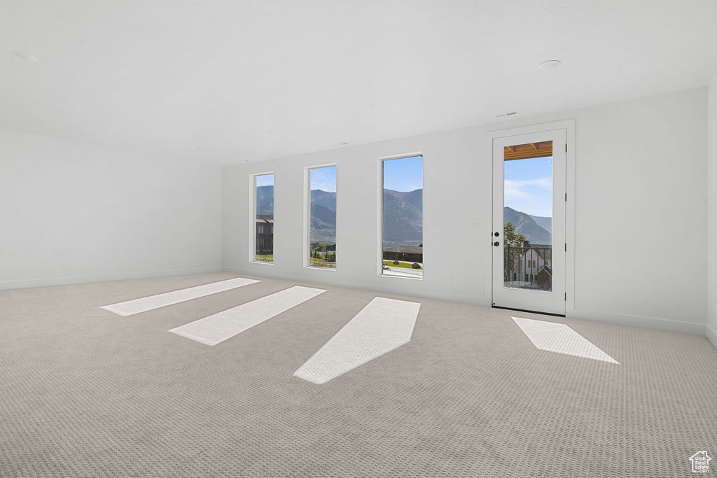Empty room with light carpet and a mountain view
