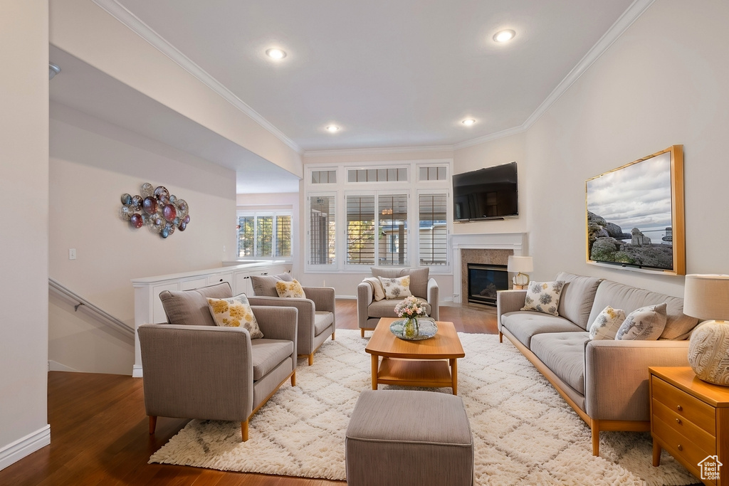 Living room with crown molding and hardwood / wood-style floors