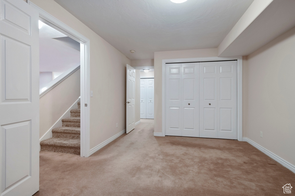 Interior space with a closet and light colored carpet