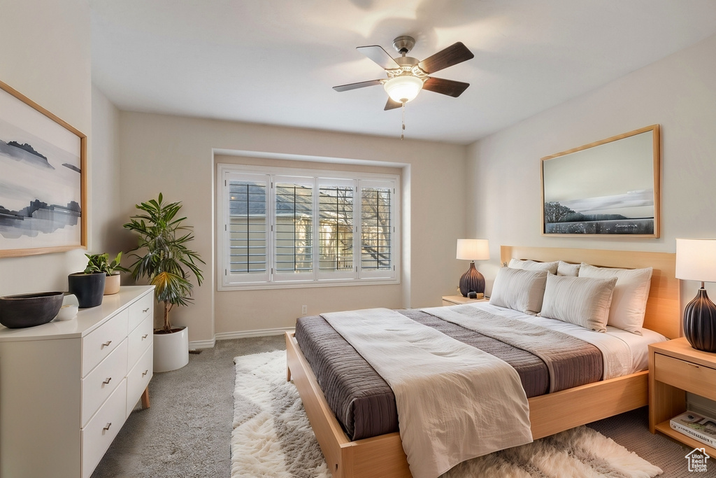 Carpeted bedroom with ceiling fan