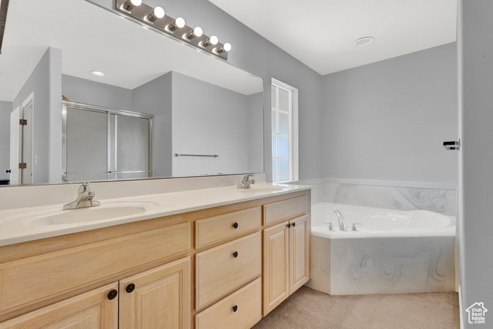 Bathroom with vanity and separate shower and tub