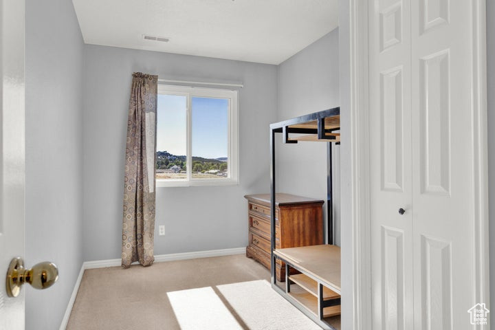 Mudroom featuring light carpet