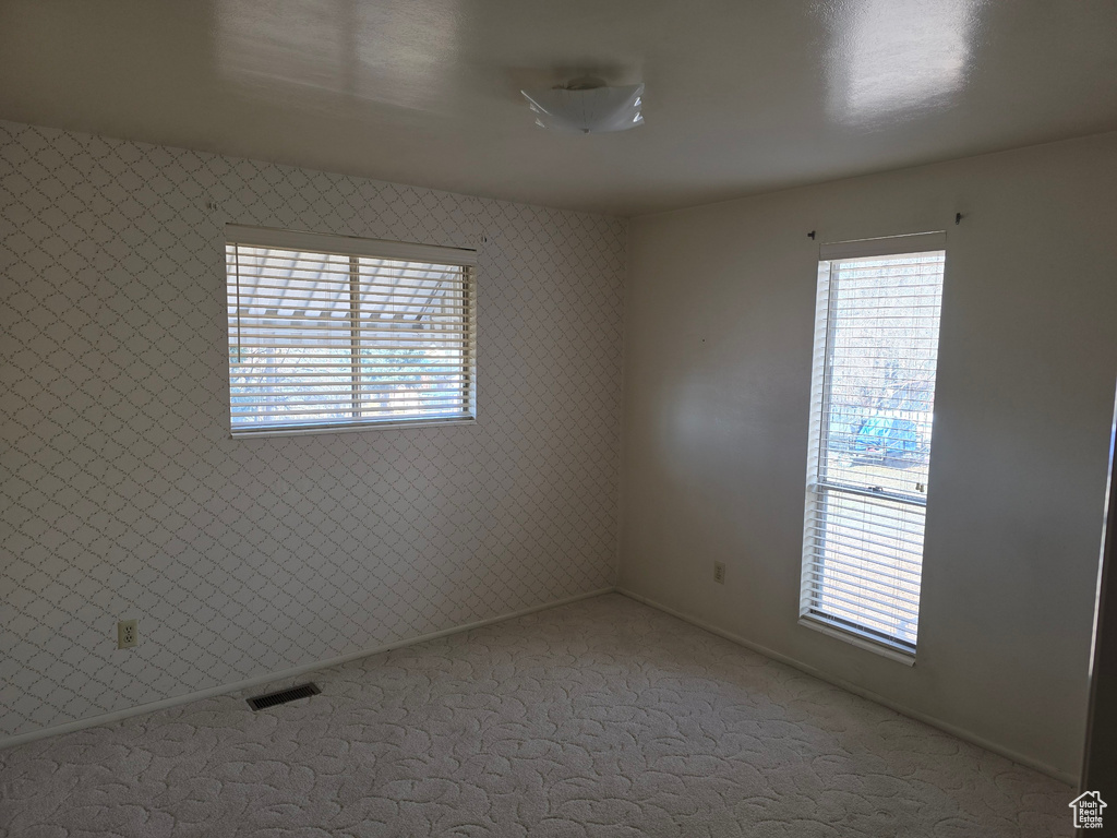 Unfurnished room featuring carpet flooring