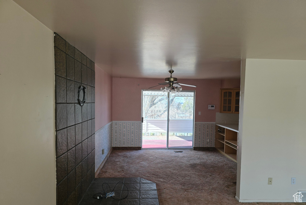 Interior space featuring ceiling fan and carpet