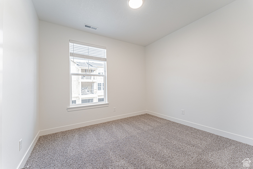 Spare room with carpet floors and baseboards