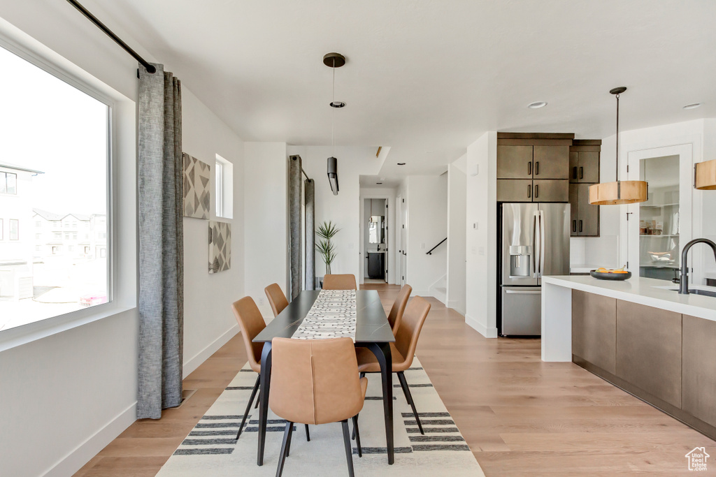 Dining room with sink and light hardwood / wood-style flooring