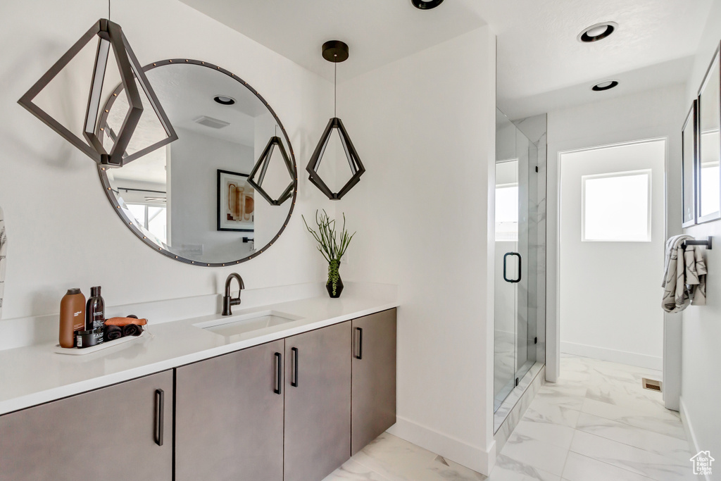 Bathroom featuring walk in shower and vanity