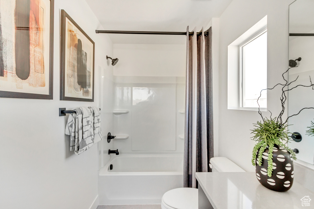 Full bathroom with vanity, toilet, and shower / tub combo with curtain