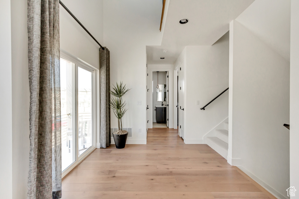 Hallway with light hardwood / wood-style floors
