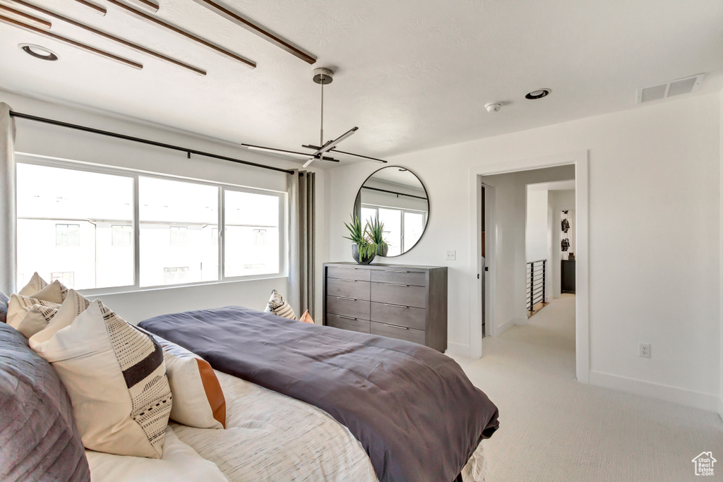 Bedroom with light colored carpet