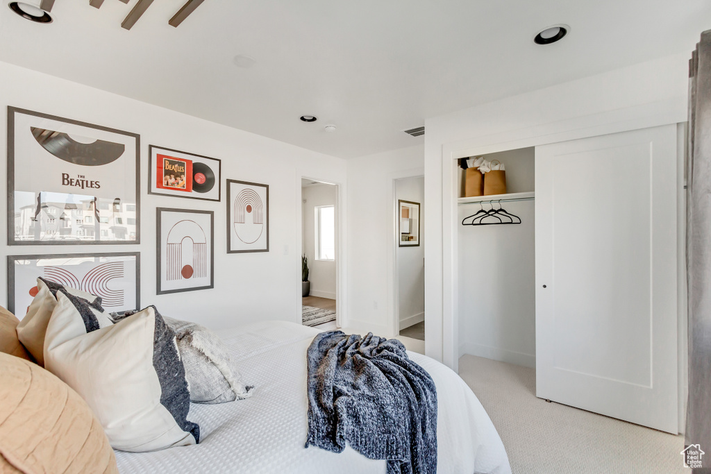 Carpeted bedroom with ceiling fan