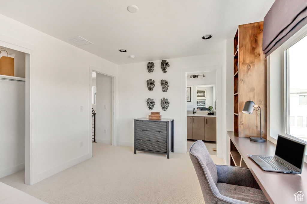 Home office with light colored carpet
