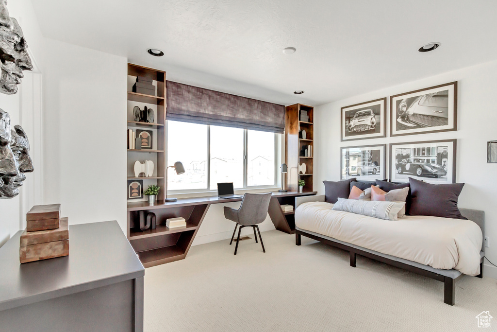 Bedroom with carpet and built in desk