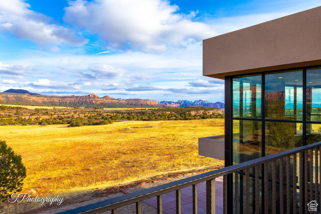 View of yard featuring a balcony and a mountain view