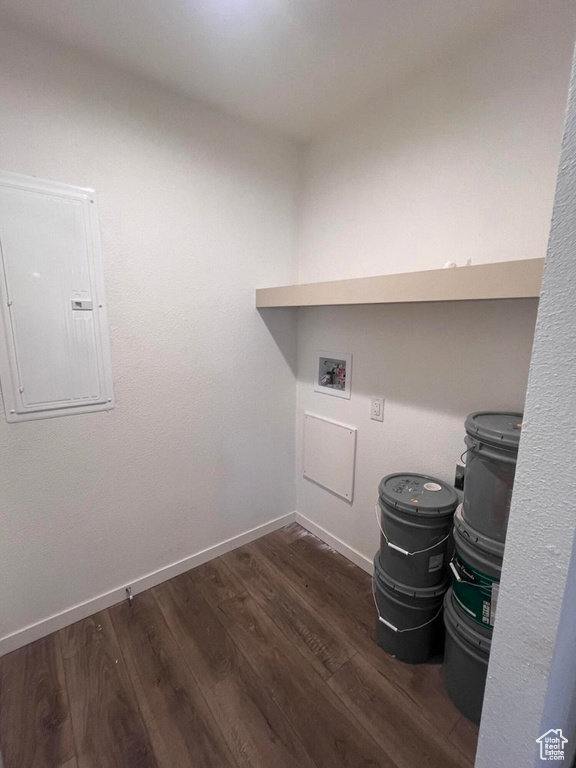 Clothes washing area with electric panel, dark wood-type flooring, and hookup for a washing machine