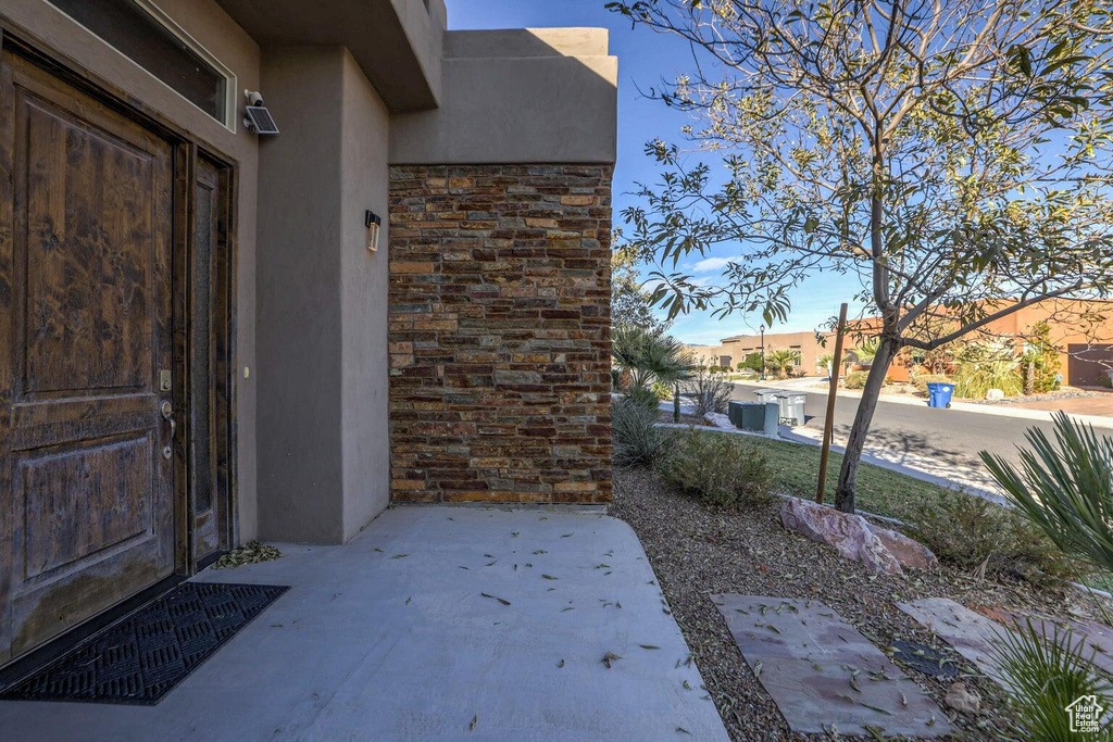 Doorway to property featuring a patio