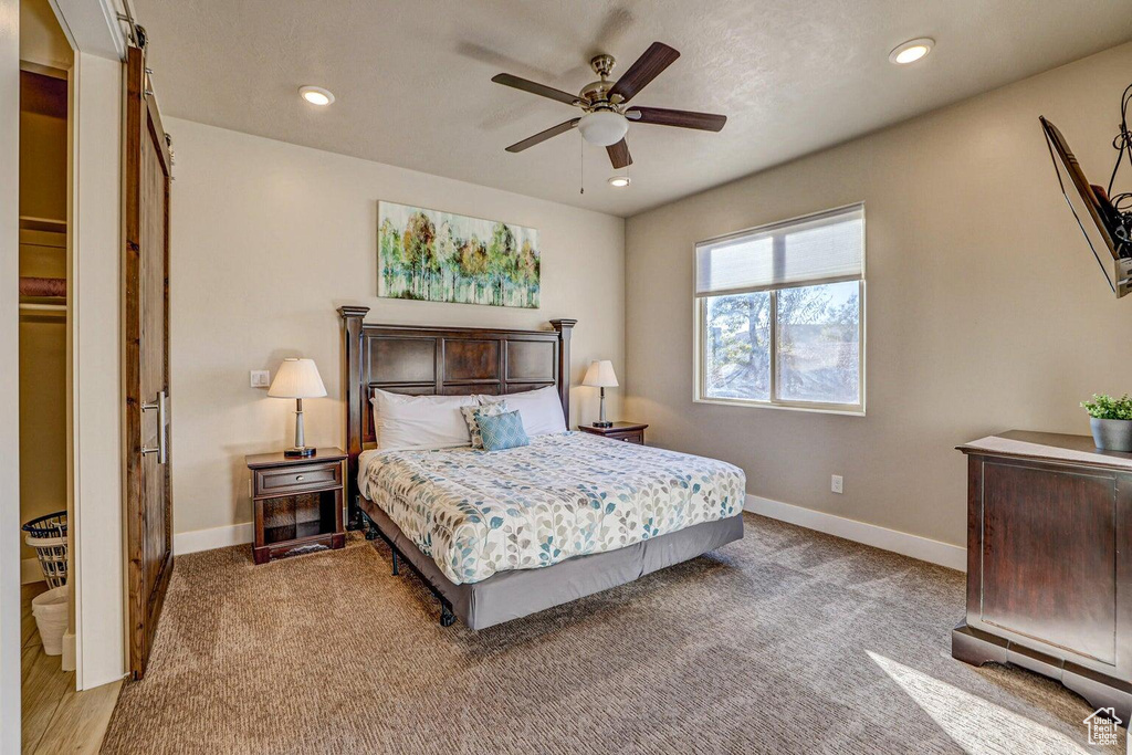 Carpeted bedroom with ceiling fan