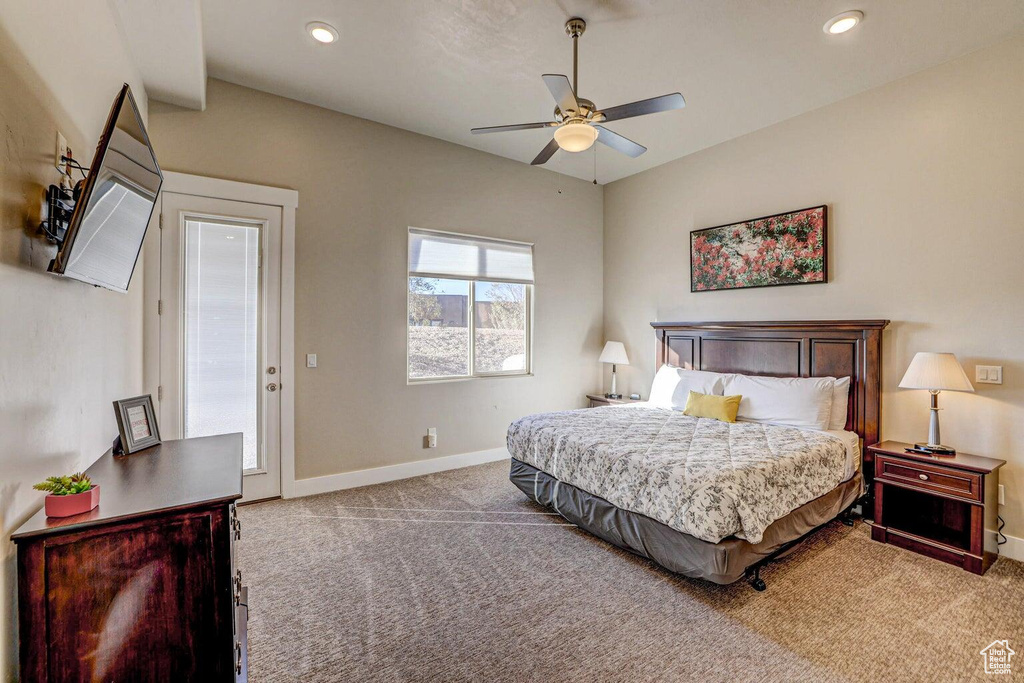 Carpeted bedroom with ceiling fan and access to outside