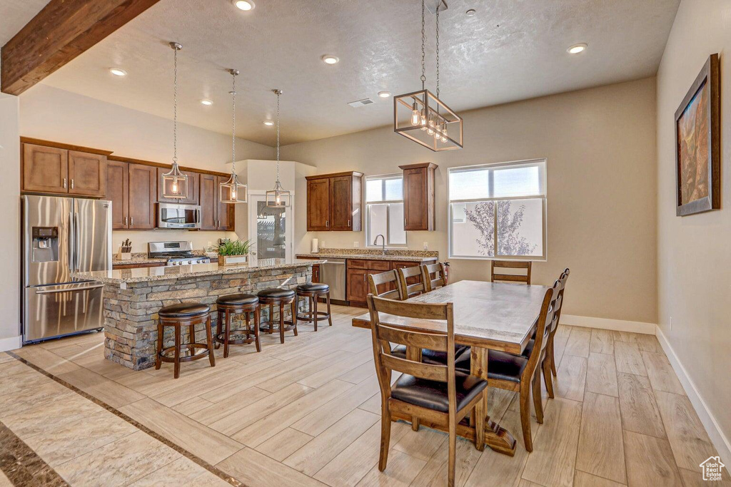 Dining room with sink and beam ceiling