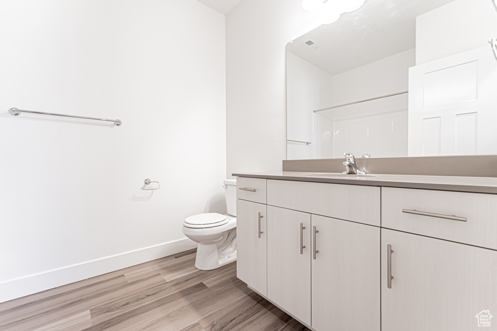 Full bathroom featuring vanity and wood finished floors