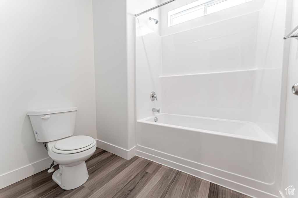 Full bathroom featuring wood finished floors and bathing tub / shower combination