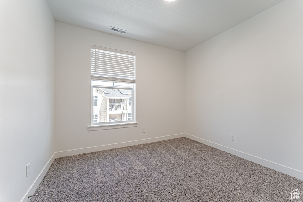 Carpeted empty room with baseboards