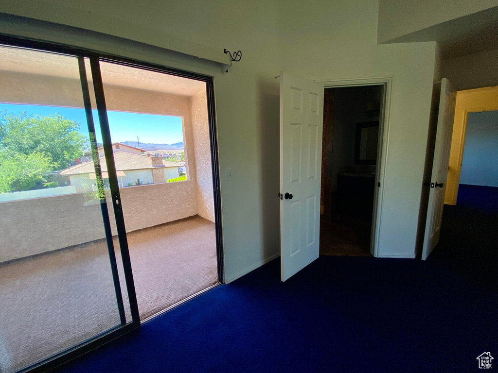 Unfurnished bedroom featuring a closet and dark carpet