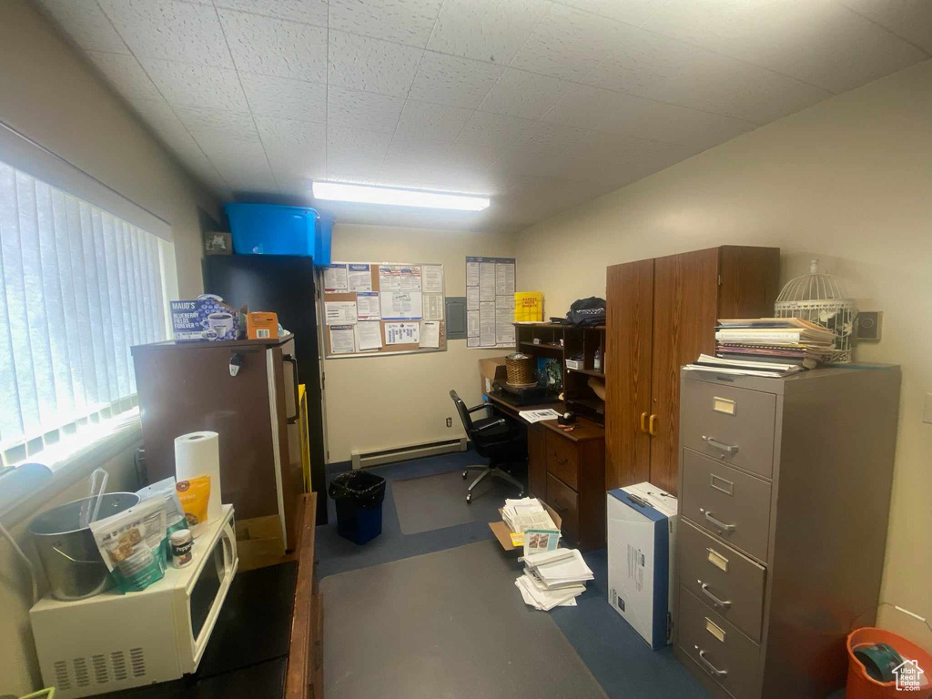 Office area featuring a baseboard radiator