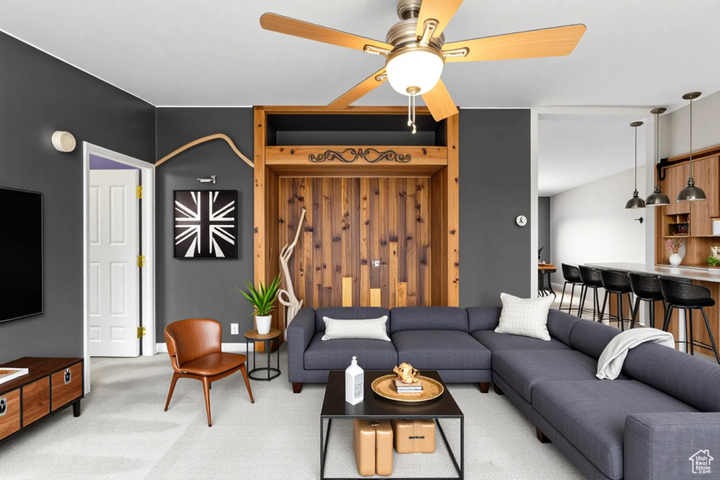 Living room with a ceiling fan and carpet floors