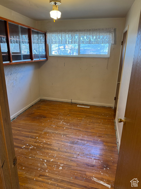 Unfurnished room with plenty of natural light and wood-type flooring