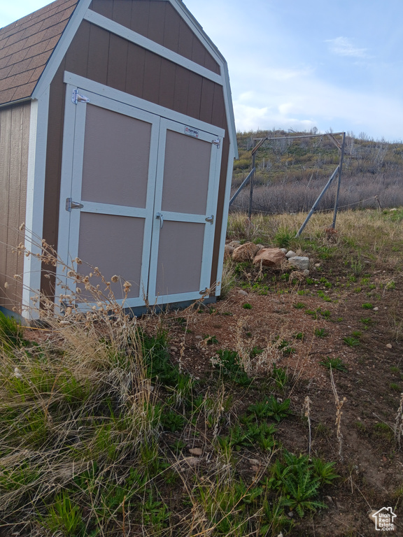 View of shed featuring fence