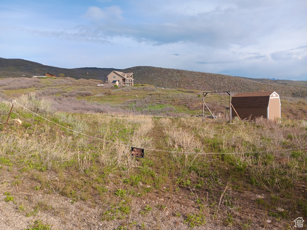 View of mountain backdrop with rural landscape