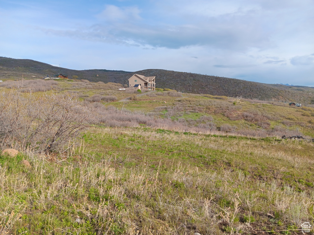 View of mountain backdrop with rural landscape