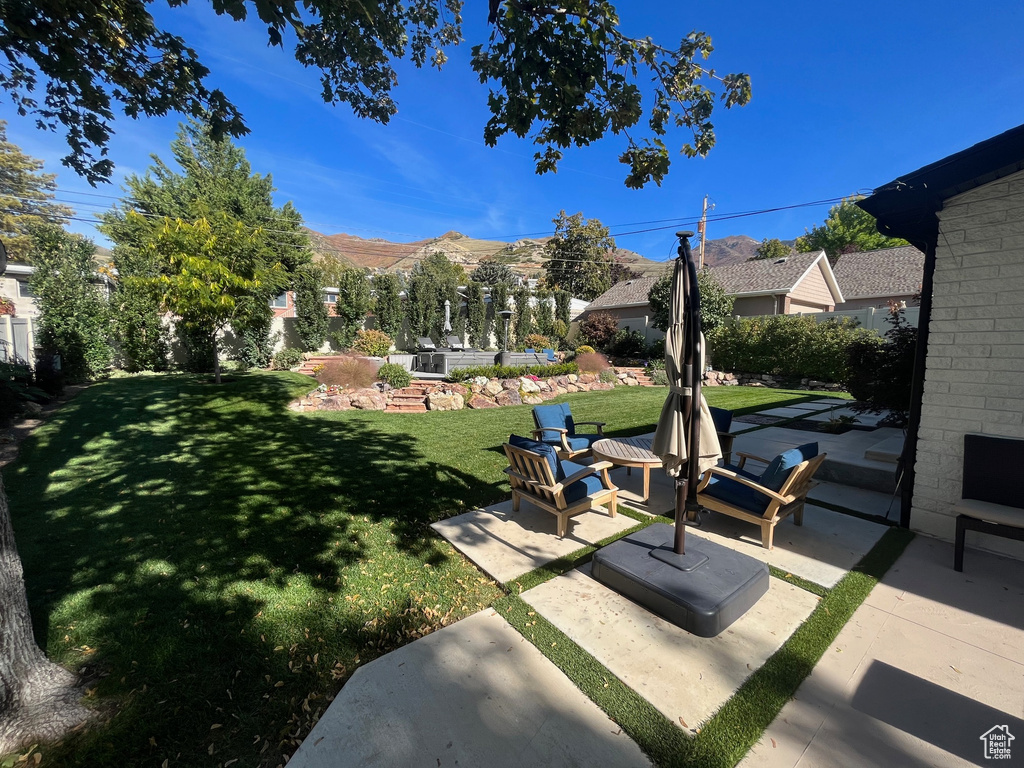 View of yard featuring a mountain view and a patio area