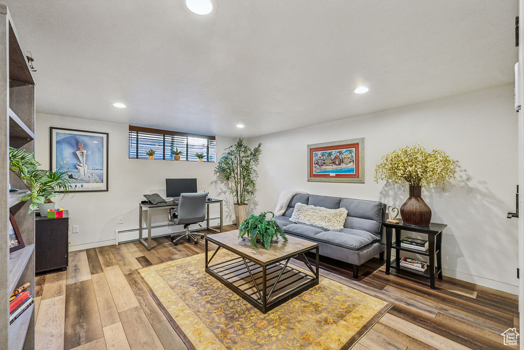 Living room featuring a baseboard radiator and hardwood / wood-style floors