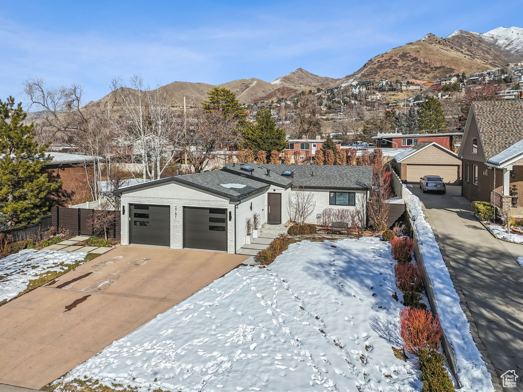 View of front facade with a mountain view and a garage