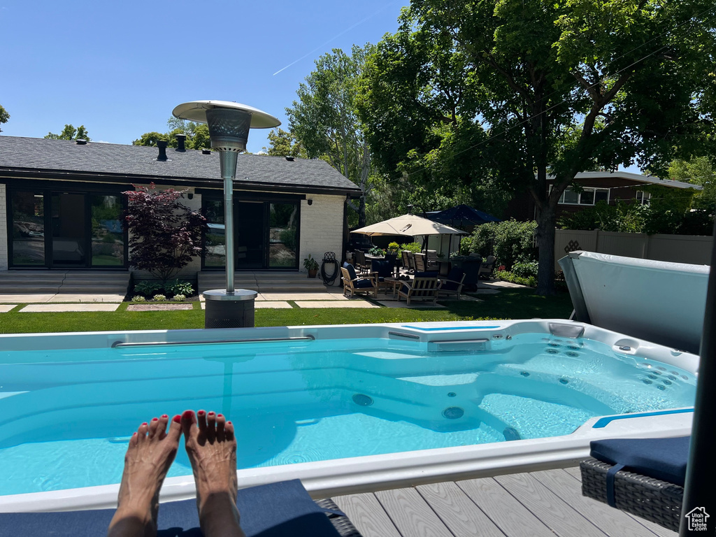 View of swimming pool with a deck