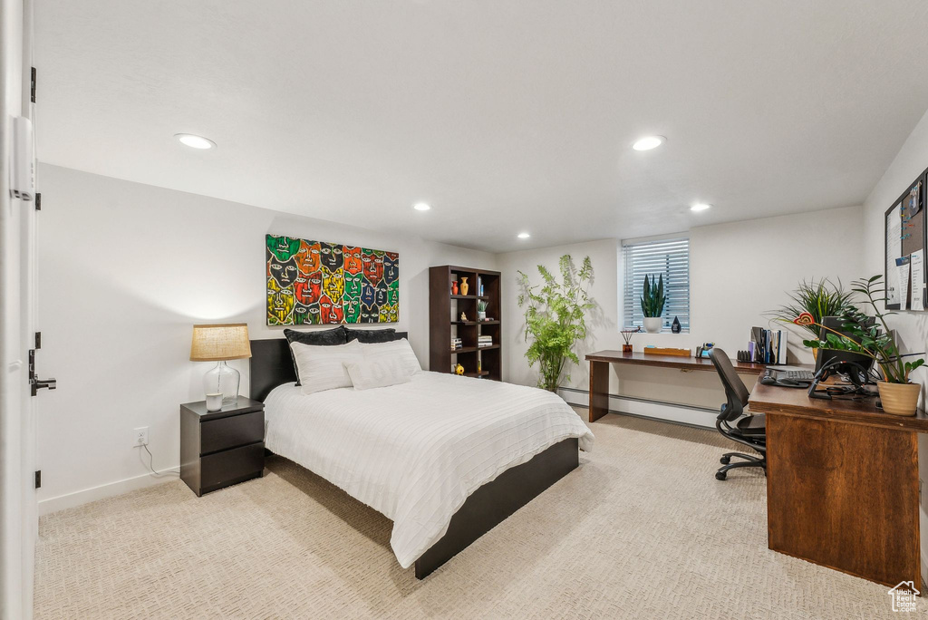 Carpeted bedroom with baseboard heating