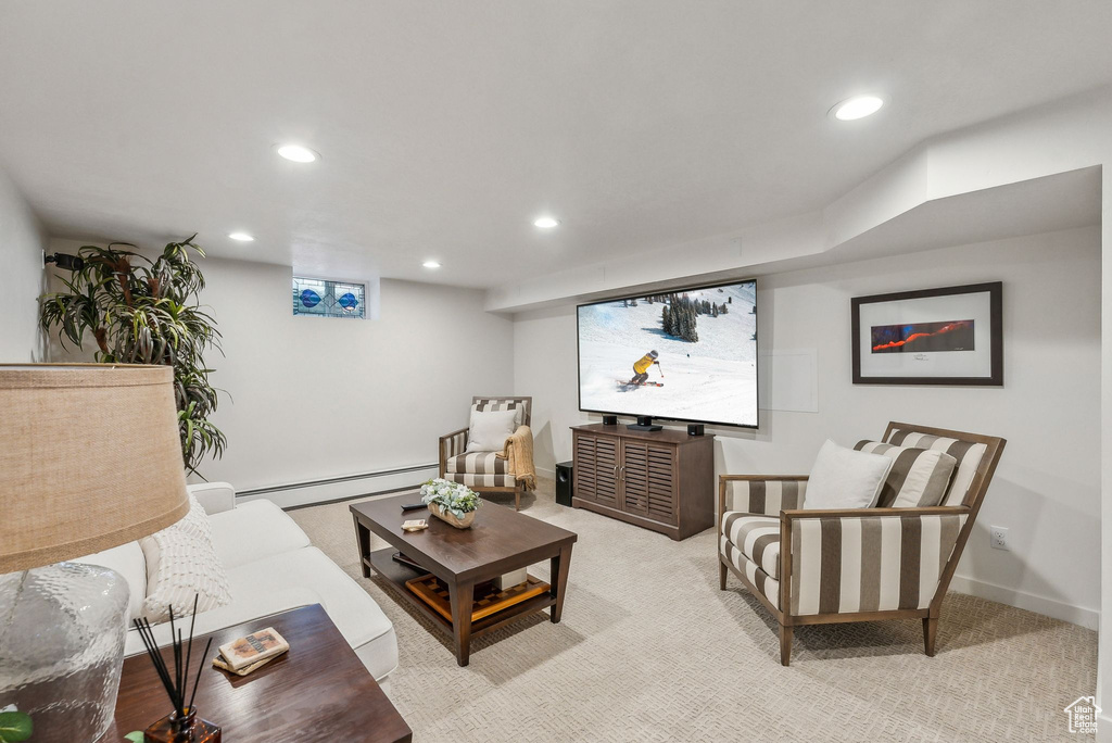 Carpeted living room featuring a baseboard radiator